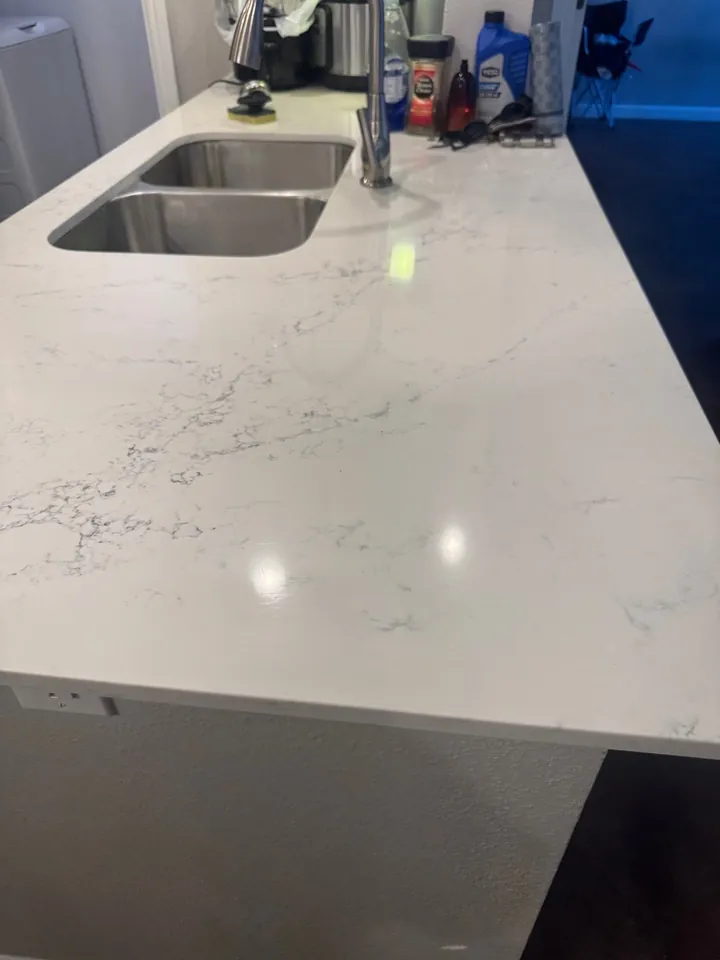 The same kitchen counter cleared and polished after a deep clean
