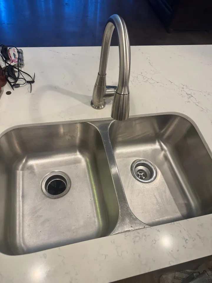The same stainless double sink scrubbed clean after a deep clean
