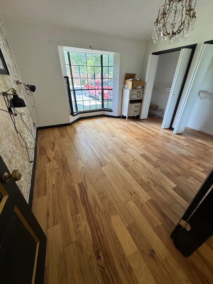The same living room cleared with floors cleaned after a post-construction clean