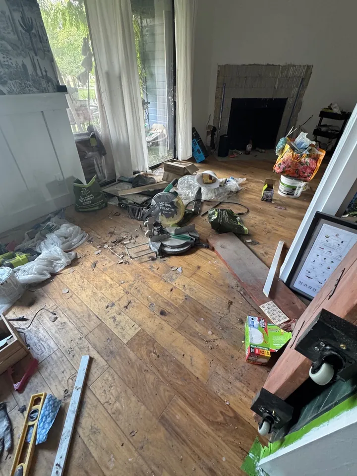 Living room full of construction debris and dust before a post-construction clean
