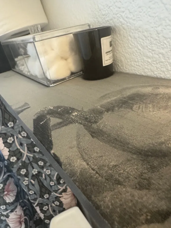 Shelf coated in construction dust before a post-construction clean